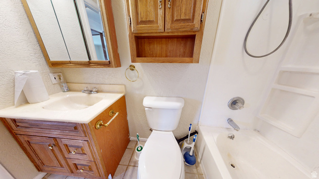 1348 Sagewood Road Price, UT 84501 - Photo 13 of 34 Bathroom featuring a textured wall, vanity, washtub / shower combination, and light tile patterned floors