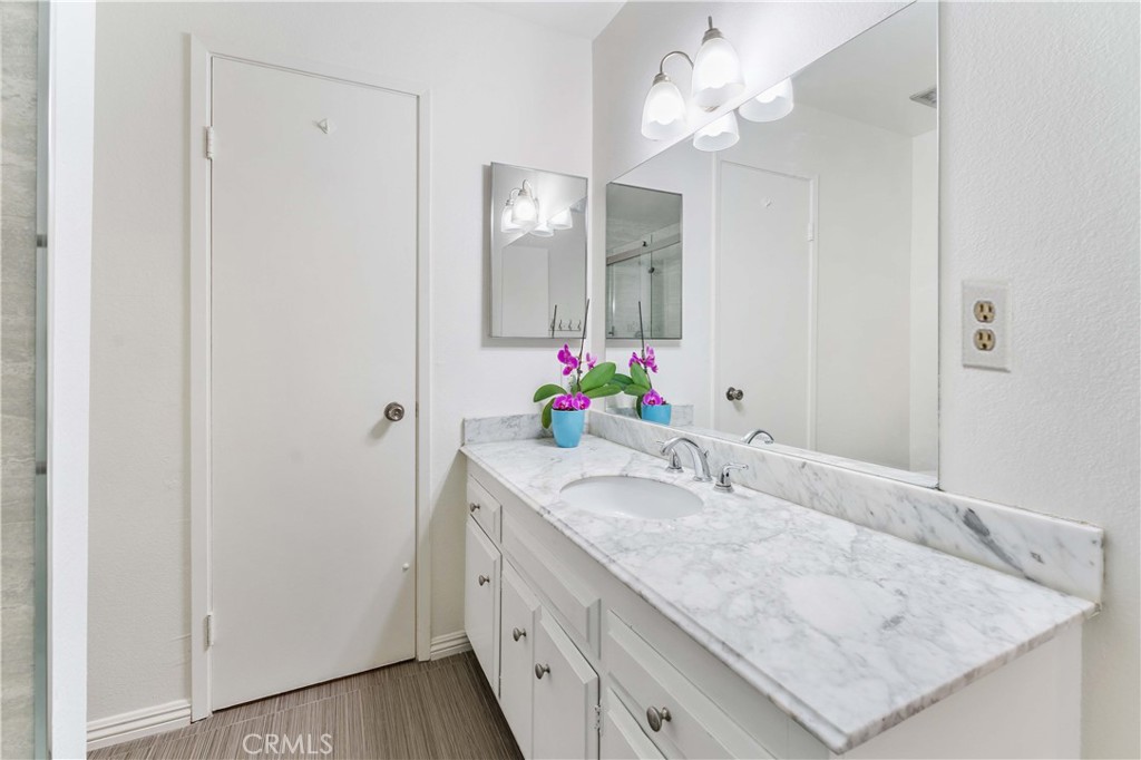 1428 Fredricks Lane Upland, CA 91786 - Photo 17 of 29 a bathroom with a granite countertop sink and a mirror