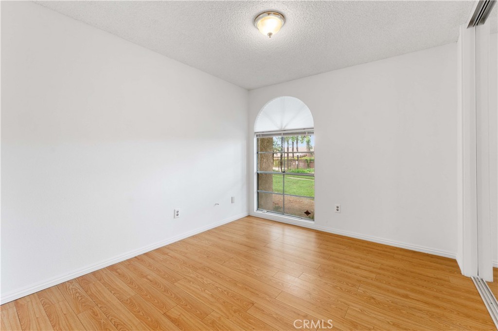 1428 Fredricks Lane Upland, CA 91786 - Photo 20 of 29 an empty room with wooden floor and windows