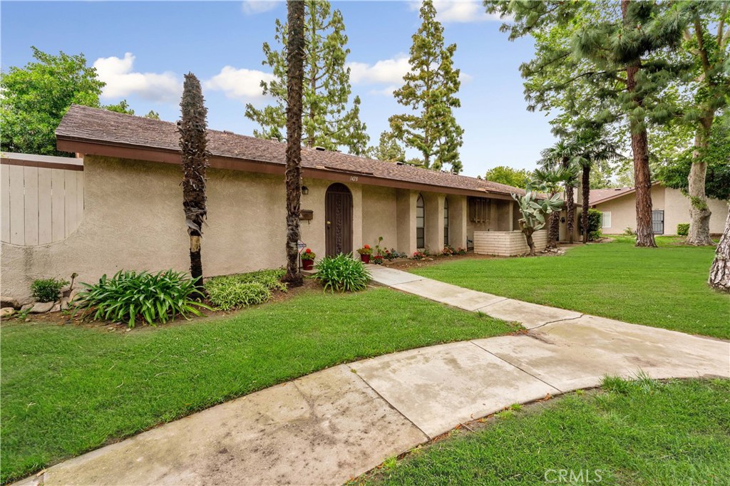 1428 Fredricks Lane Upland, CA 91786 - Photo 25 of 29 a front view of a house with a garden and yard