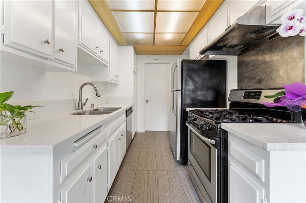 1428 Fredricks Lane Upland, CA 91786 - Photo 5 of 29 a kitchen with stainless steel appliances granite countertop a sink stove and refrigerator