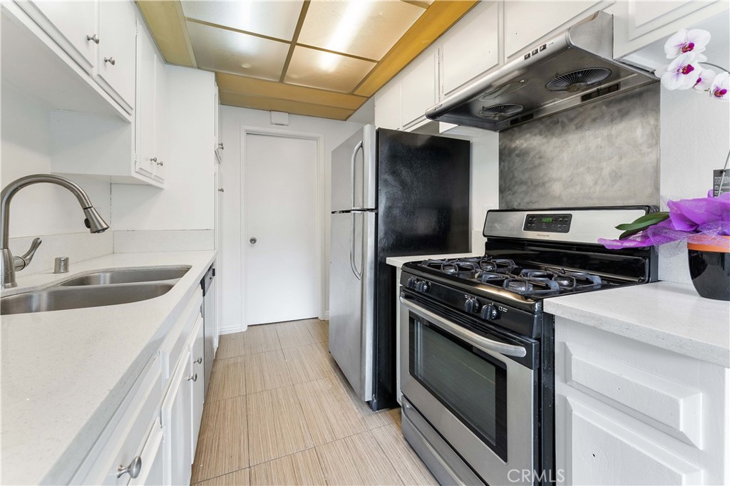 1428 Fredricks Lane Upland, CA 91786 - Photo 6 of 29 a kitchen with a stove and a sink