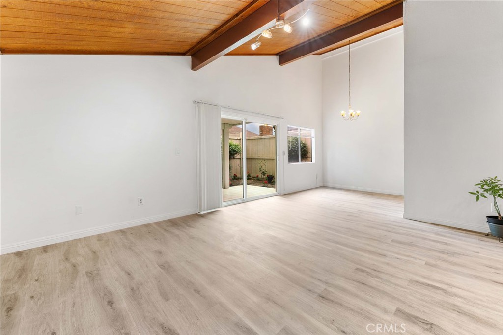1428 Fredricks Lane Upland, CA 91786 - Photo 10 of 29 an empty room with wooden floor and windows