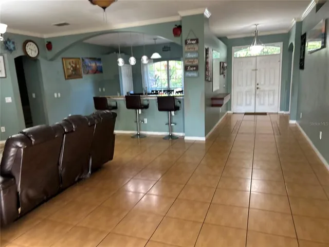 a living room with granite countertop furniture and a chandelier