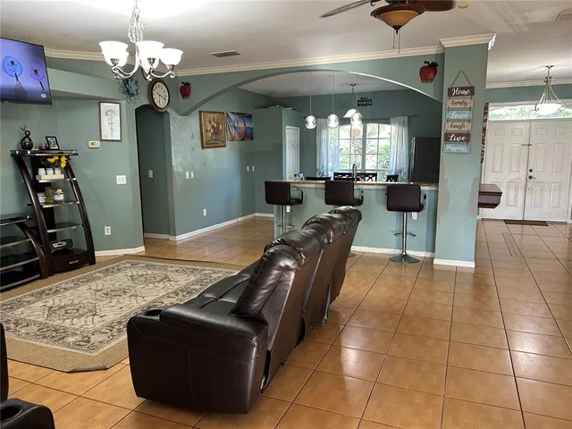 a living room with furniture a window and a chandelier
