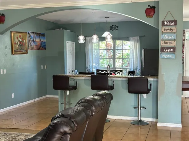 a view of a hallway with wooden floor and chandelier