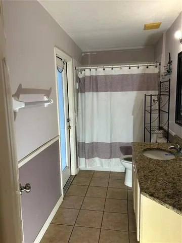 a bedroom with furniture and a book shelf