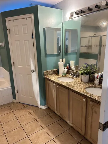 a bathroom with a shower and a chair