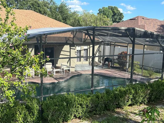 a view of a patio with table and chairs under an umbrella