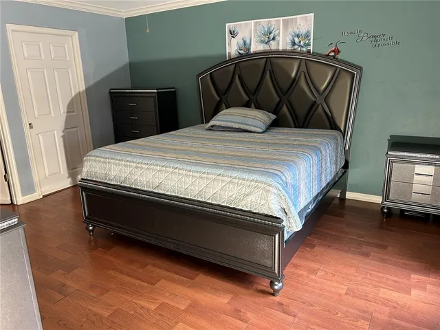 a bedroom with a bed and a night stand