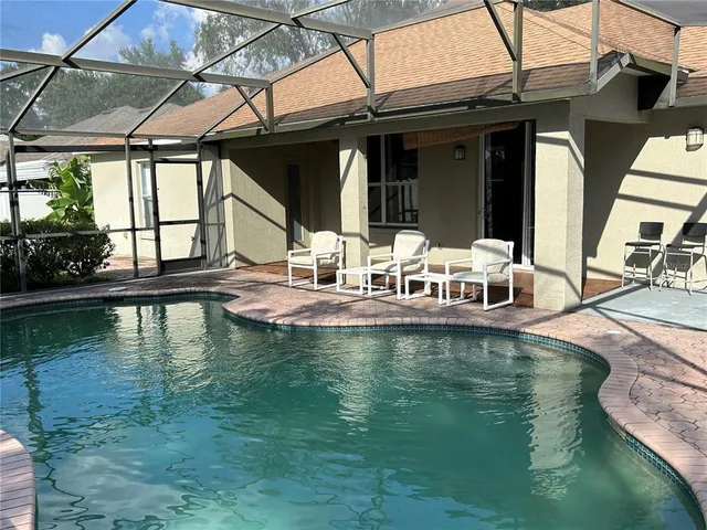a view of a swimming pool with a patio