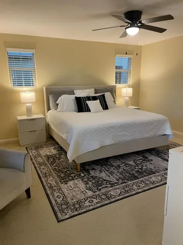 a bedroom with two beds and painting on the wall