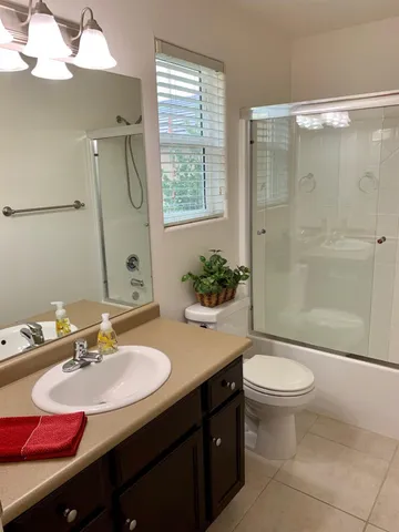 a kitchen with kitchen island stainless steel appliances a sink and a living room