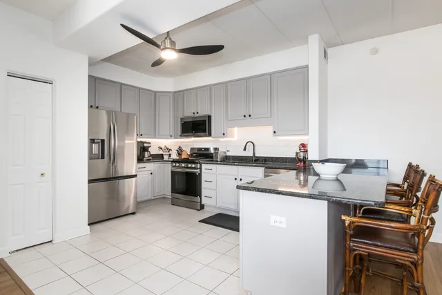 a kitchen with a sink appliances and cabinets