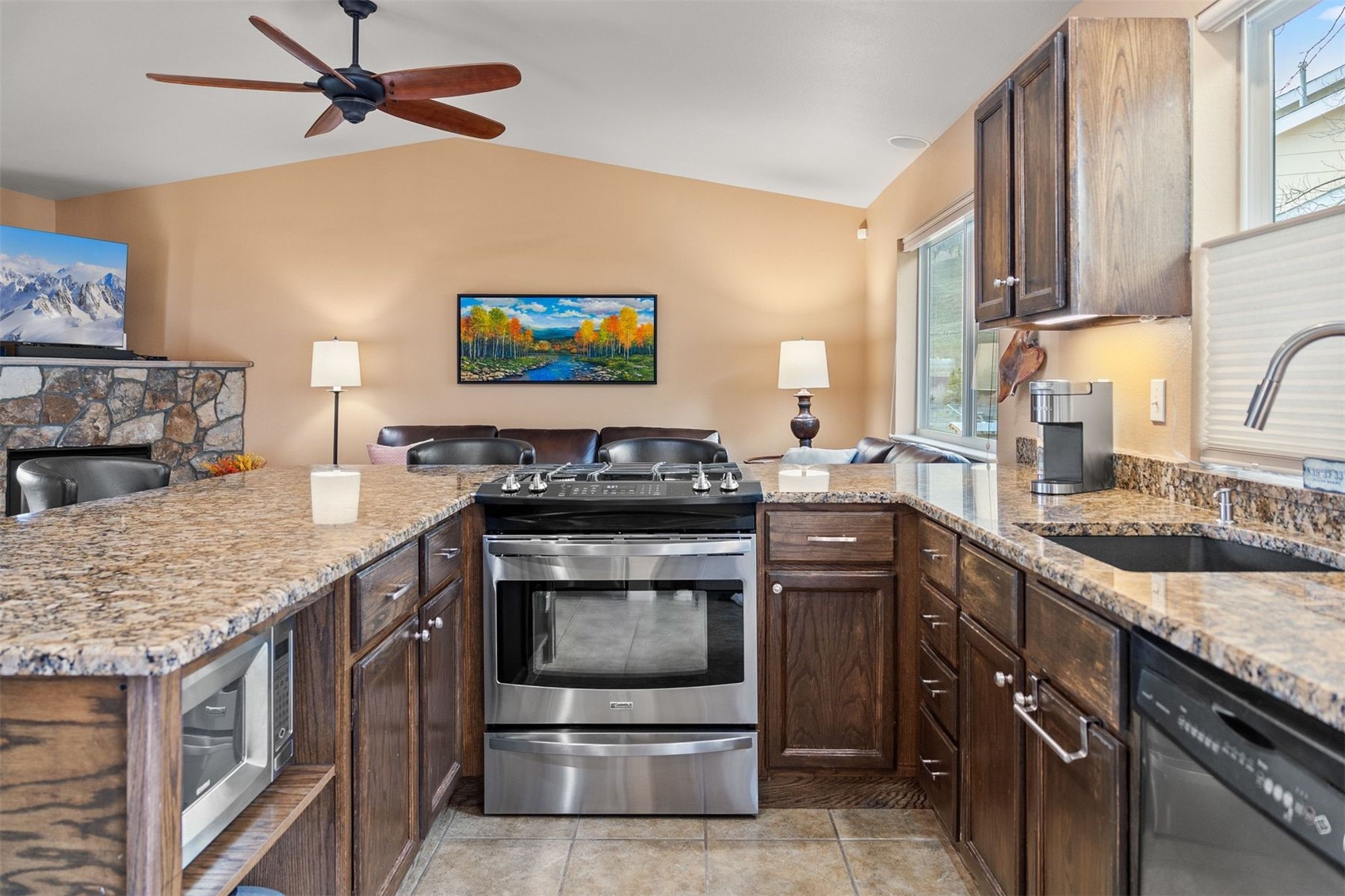 588 Alpine Road Dillon, CO 80435 - Photo 5 of 41 Kitchen with lofted ceiling, appliances with stainless steel finishes, sink, ceiling fan, and light tile floors