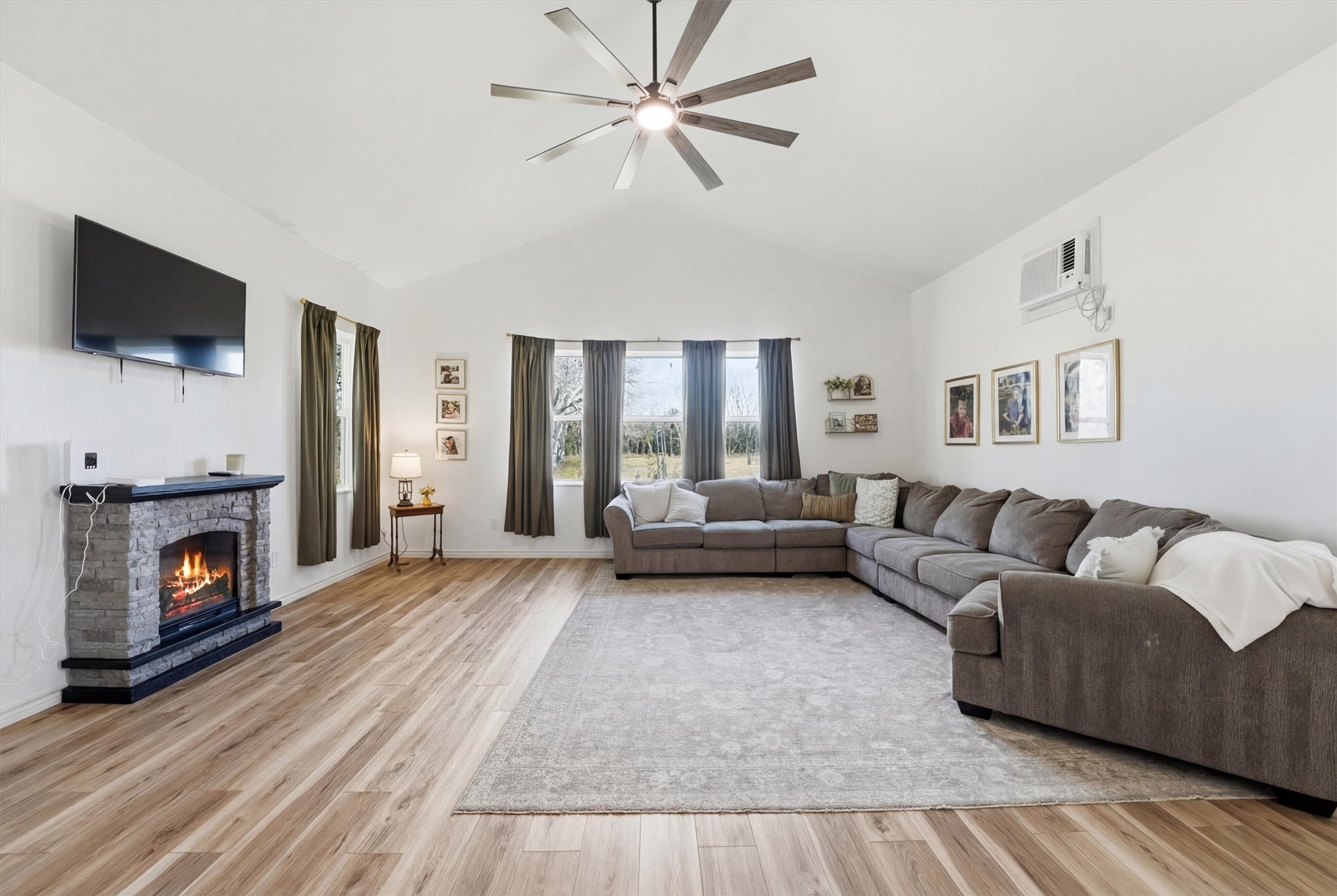 611 Reidland Road Crosby, TX 77532 - Photo 6 of 33 a living room with furniture a flat screen tv and a fireplace