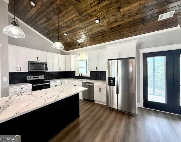 a kitchen with refrigerator and stove