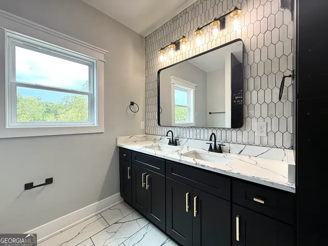 a bathroom with a double vanity sink and a mirror