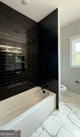 a bathroom with a bathtub and a shower