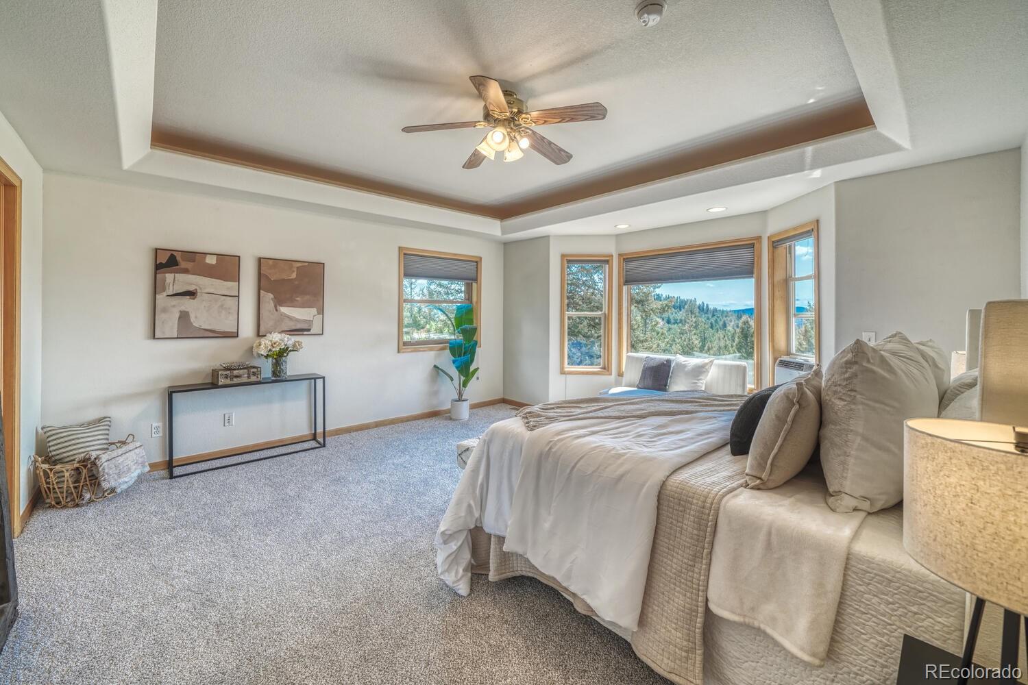50 Ridge Lane Bailey, CO 80421 - Photo 12 of 37 a spacious bedroom with a bed and a table