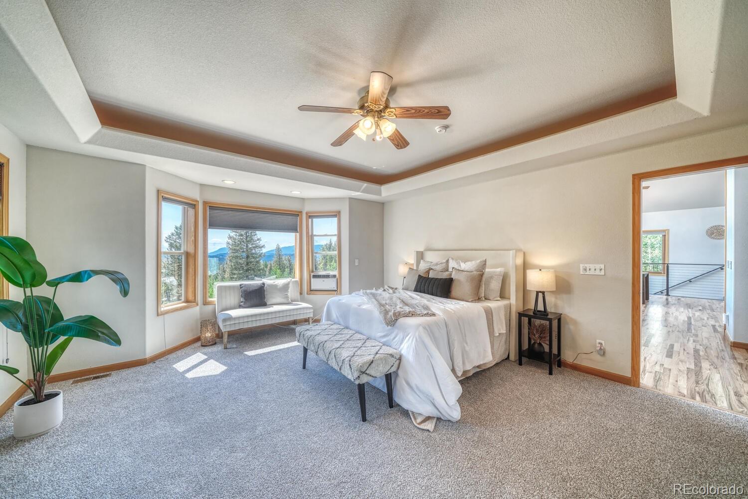 50 Ridge Lane Bailey, CO 80421 - Photo 13 of 37 a bed room with a bed and a chandelier