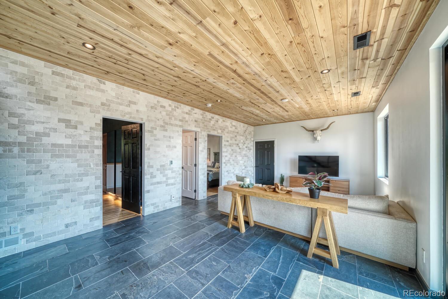 50 Ridge Lane Bailey, CO 80421 - Photo 18 of 37 a living room with furniture and a wooden floor