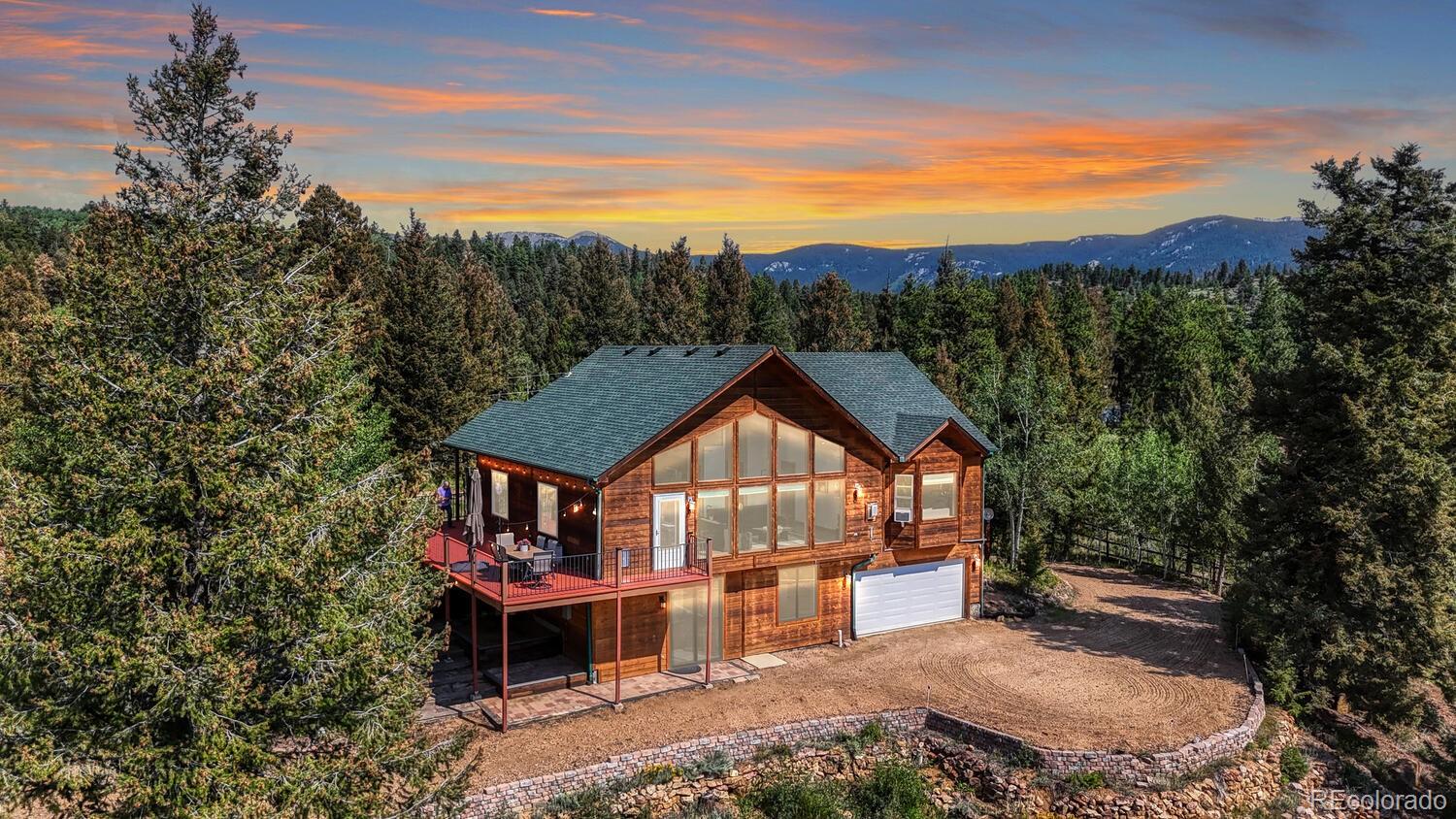 50 Ridge Lane Bailey, CO 80421 - Photo 2 of 37 a view of a big house with a big yard and large tree