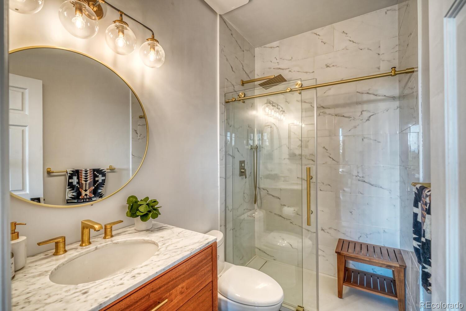 50 Ridge Lane Bailey, CO 80421 - Photo 22 of 37 a bathroom with a granite countertop sink toilet and shower