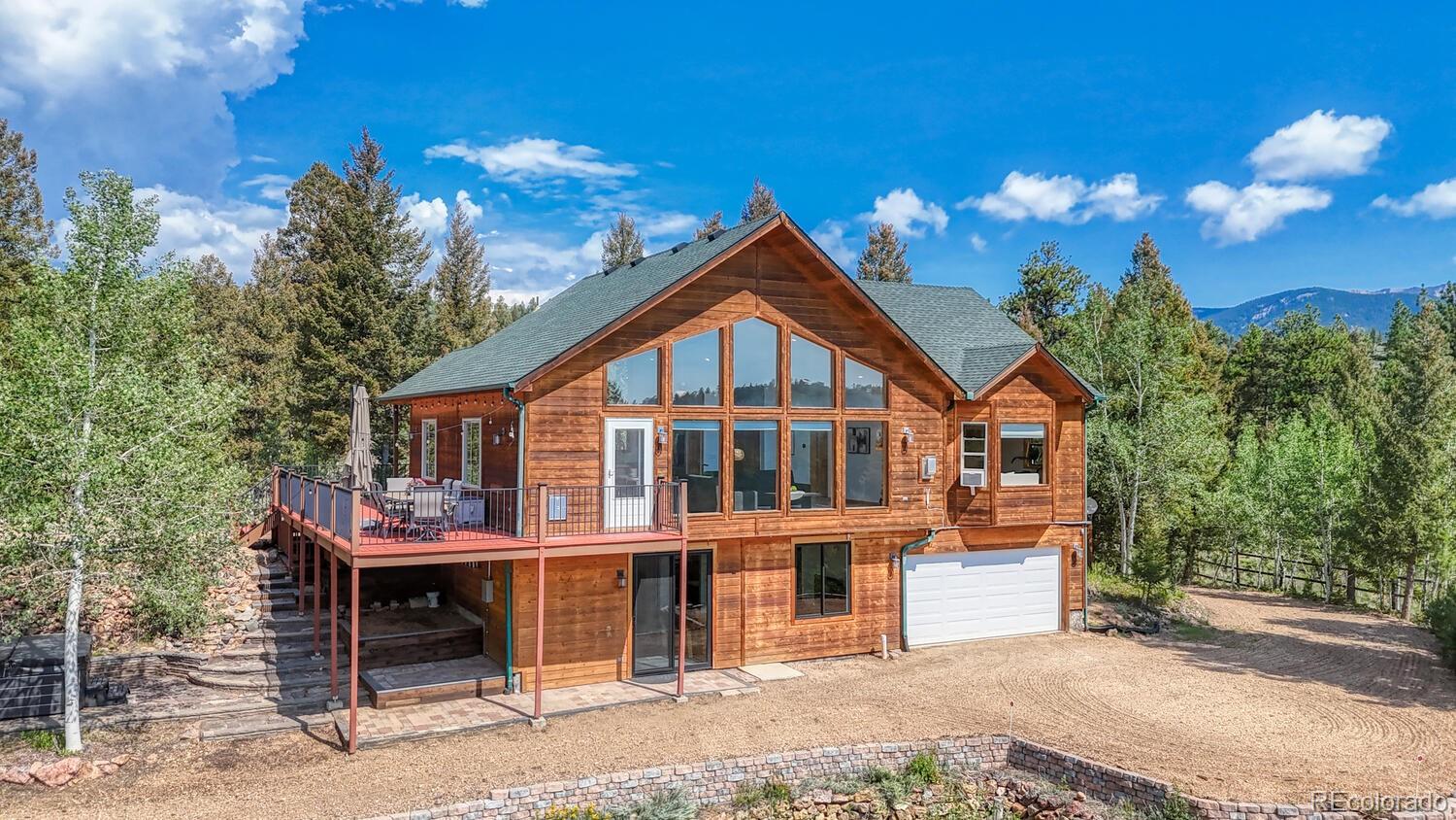 50 Ridge Lane Bailey, CO 80421 - Photo 3 of 37 a front view of a house with a yard
