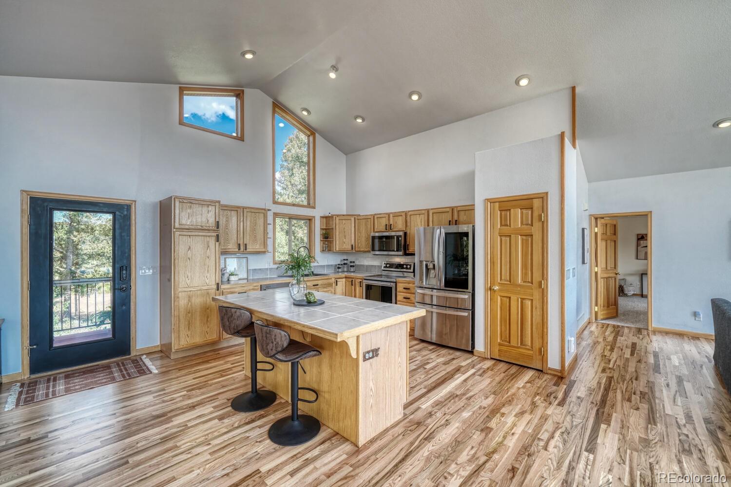 50 Ridge Lane Bailey, CO 80421 - Photo 6 of 37 a kitchen with a sink appliances cabinets and wooden floor