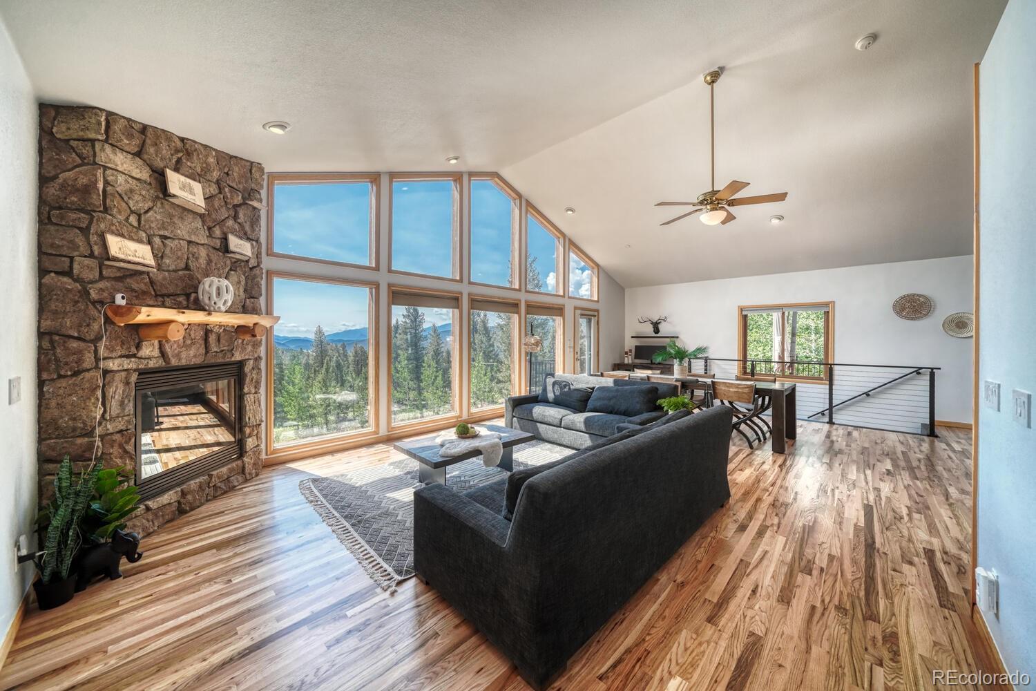 50 Ridge Lane Bailey, CO 80421 - Photo 9 of 37 a living room with furniture and a floor to ceiling window