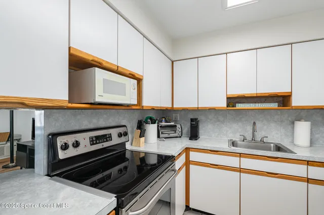 a kitchen with stainless steel appliances granite countertop a stove and a sink
