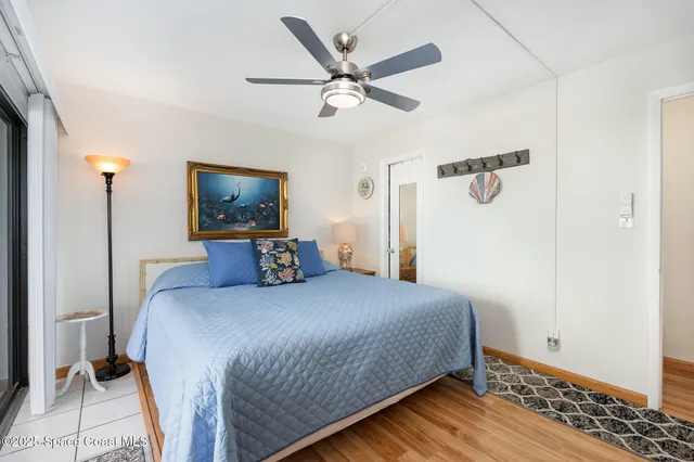 a bedroom with a bed and a wall painting