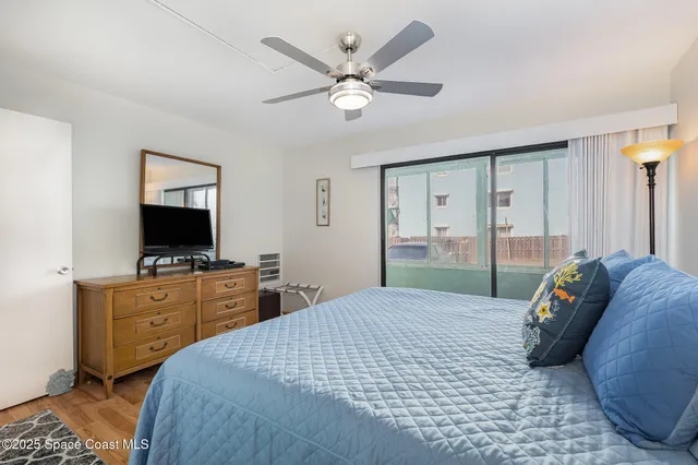 a bedroom with a large bed and a flat screen tv