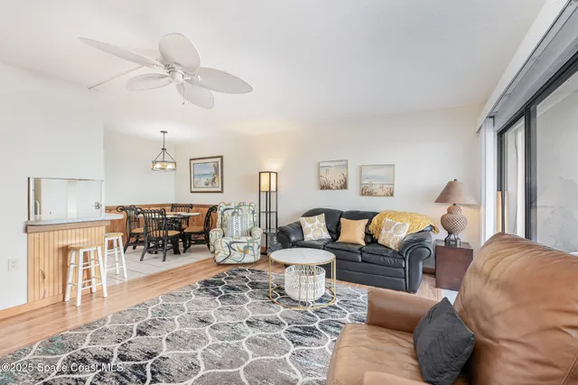 a living room with furniture and a dining table