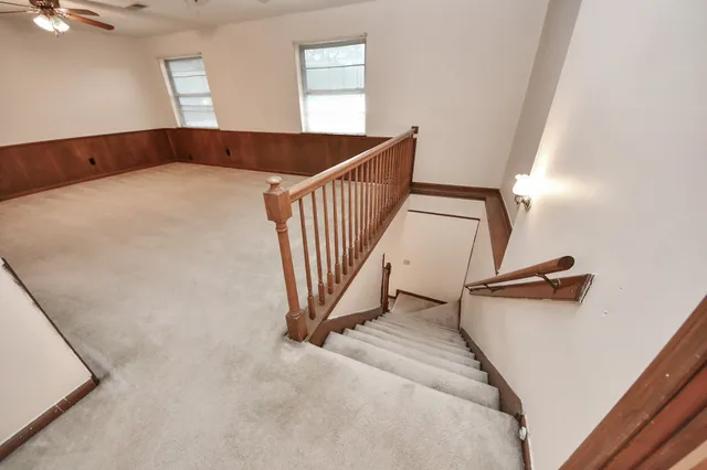 a view of a hallway to a bedroom and a window