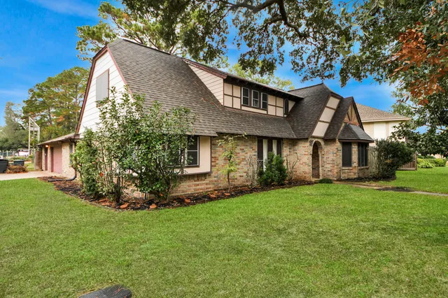 a view of a backyard with a garden and entertaining space