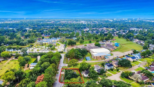 an aerial view of a house with garden space and street view