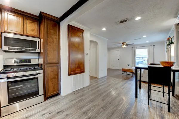 a kitchen with stainless steel appliances granite countertop a stove a refrigerator and a microwave