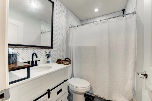 a bathroom with a sink toilet and shower