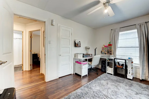 a view of a workspace with furniture and wooden floor