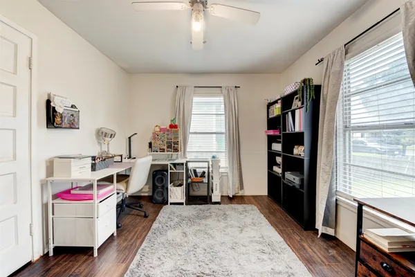 a view of a workspace with furniture and a window