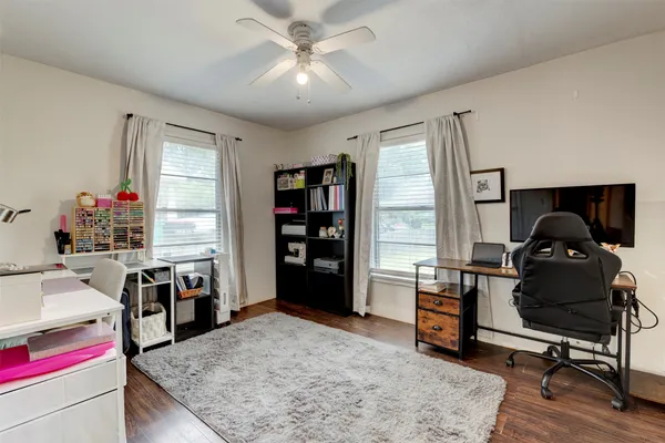 a view of a workspace with furniture and a window