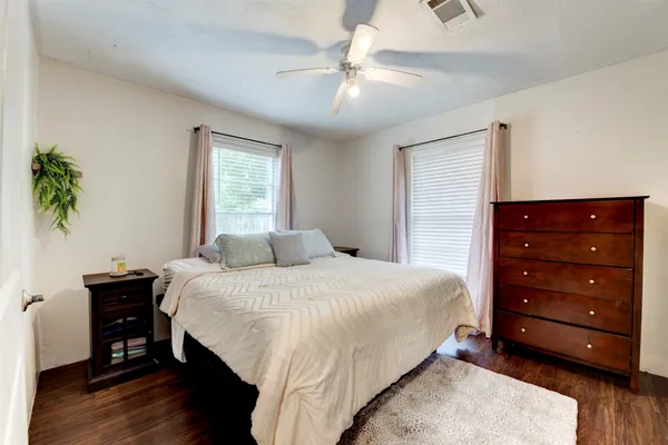 a bedroom with a bed and a potted plant