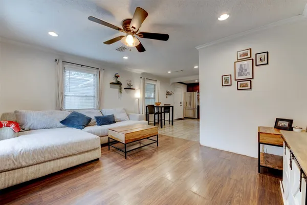 a living room with furniture and a wooden floor