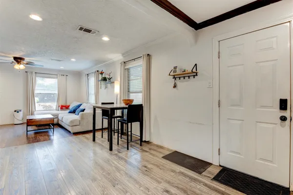 a living room with furniture and wooden floor