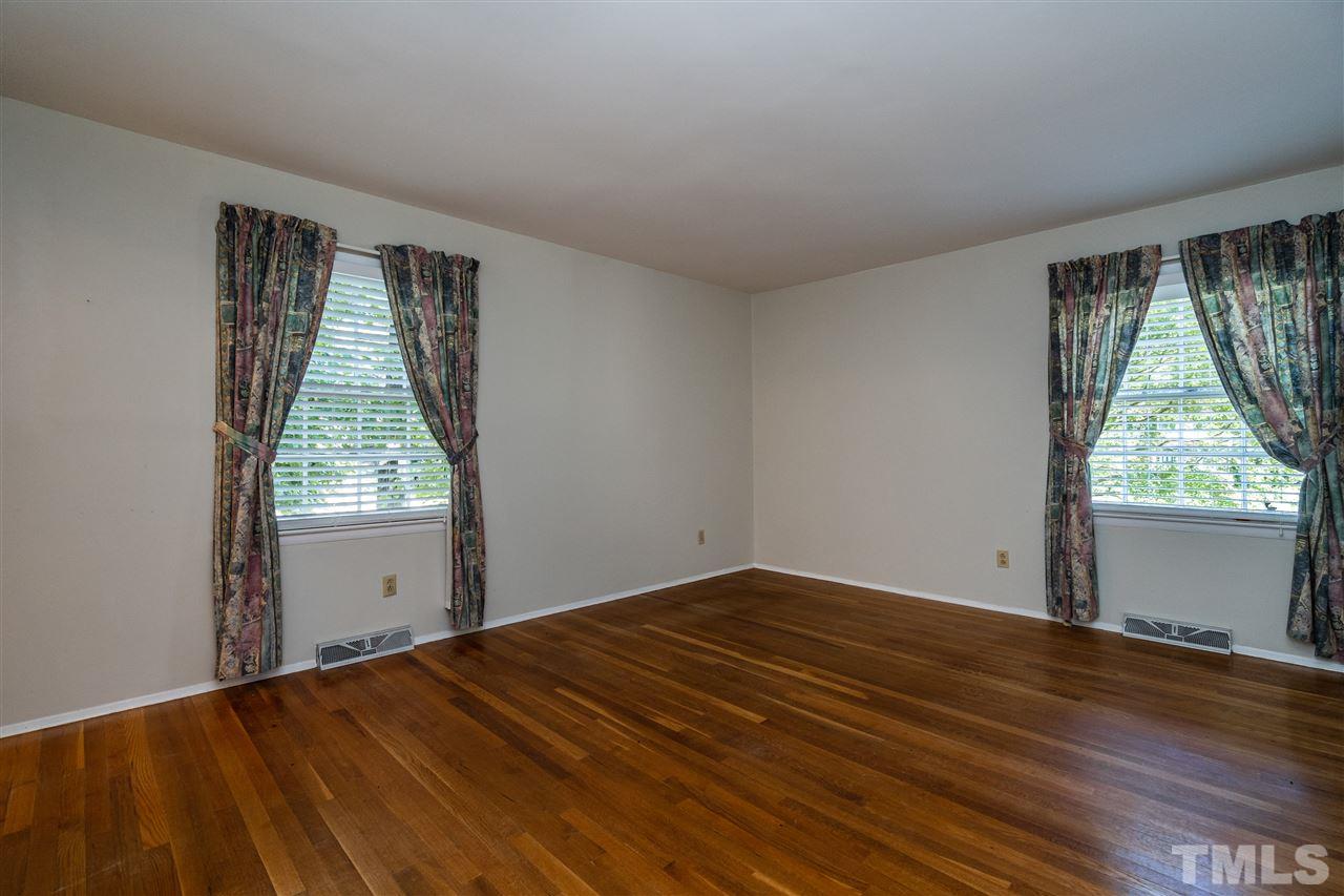 4708 Latimer Road Raleigh, NC 27609 - Photo 8 of 22 a view of empty room with wooden floor and fan