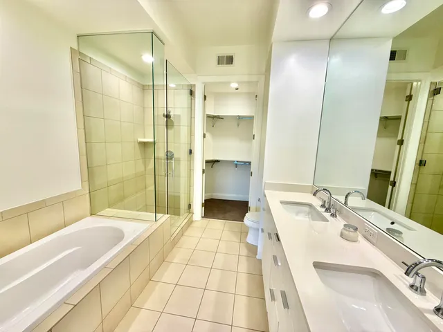 a bathroom with a double vanity sink and mirror