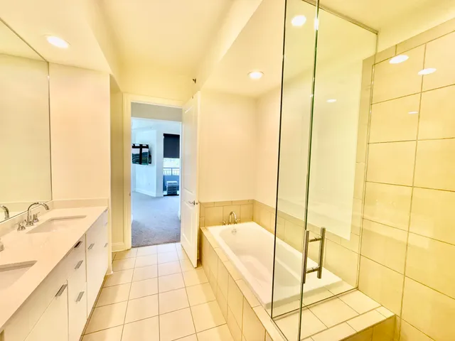 a bathroom with a bathtub and a shower