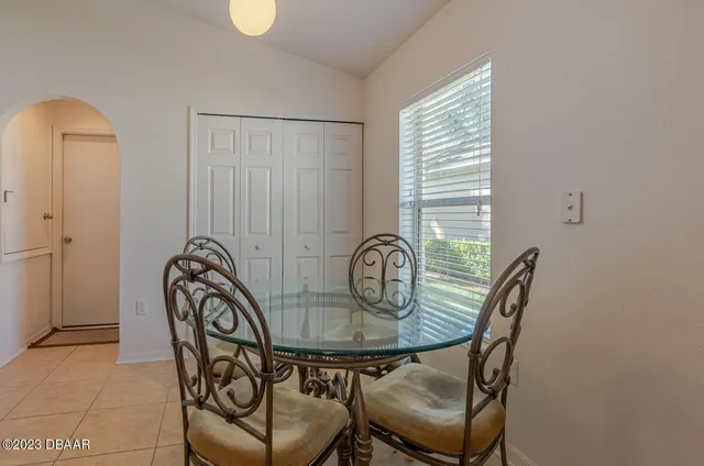 a dining room with furniture and window